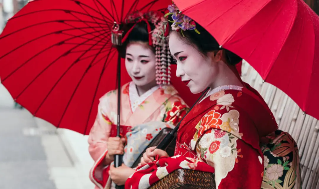 Maiko geishas walking on a street of Gion