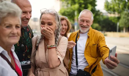 A group of solo travellers laughing together