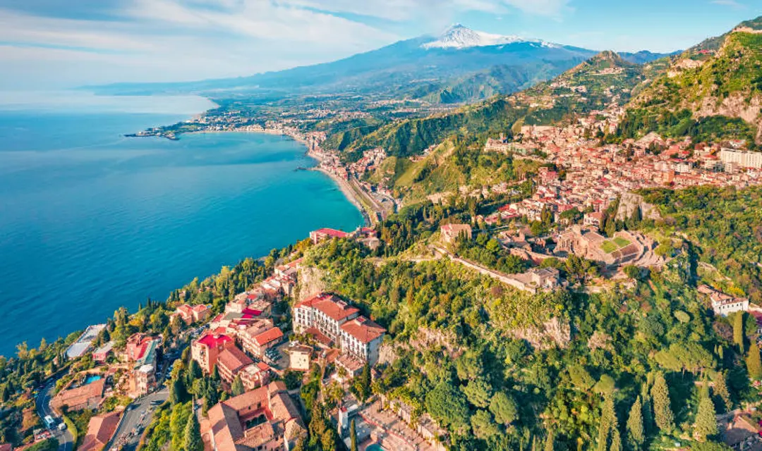 An aerial view of Taormina with Mount Etna in the background in Sicily, Italy